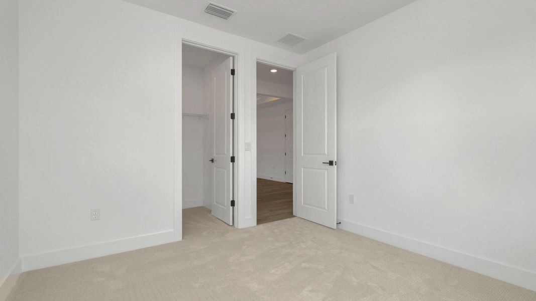 The Fourth Bedroom of a DRB Homes Grand Hawk which is offered as a home plan at Serengeti in Spring Hill, FL.