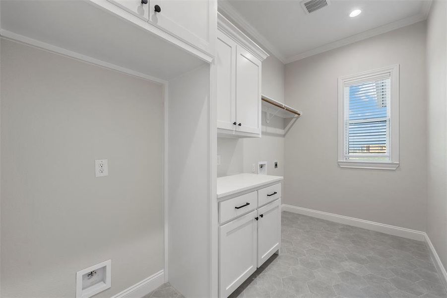 Laundry room with crown molding, washer hookup, electric dryer hookup, cabinet space, and recessed lighting Laundry room with crown molding, washer hookup, electric dryer hookup, cabinet space, and recessed lighting