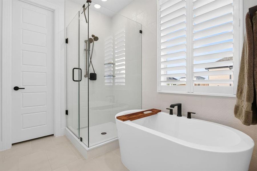 The free-standing tub and frameless glass shower continue the tone of sophistication and quiet luxury. The free-standing tub and frameless glass shower continue the tone of sophistication and quiet luxury.