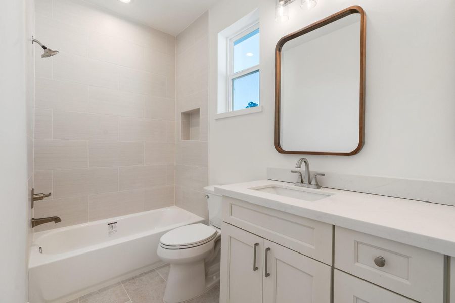 The upstairs secondary bathroom is thoughtfully designed with a chic double vanity and elegant finishes that bring a polished feel to the space. The upstairs secondary bathroom is thoughtfully designed with a chic double vanity and elegant finishes that bring a polished feel to the space.