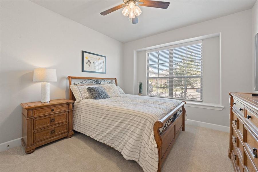Bedroom featuring light colored carpet and ceiling fan