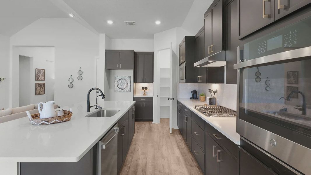 Representative furnished interior of a home built from the Brooks by Chesmar Homes in University Heights, Round Rock (Image 13).