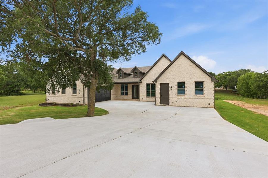 Front exterior of a new home in , Granbury, TX, highlighting curb appeal (Image 1). Front exterior of a new home in , Granbury, TX, highlighting curb appeal (Image 1).