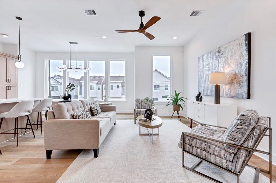 Bright and airy living room with expansive glass windows that flood the space with natural light. Bright and airy living room with expansive glass windows that flood the space with natural light.