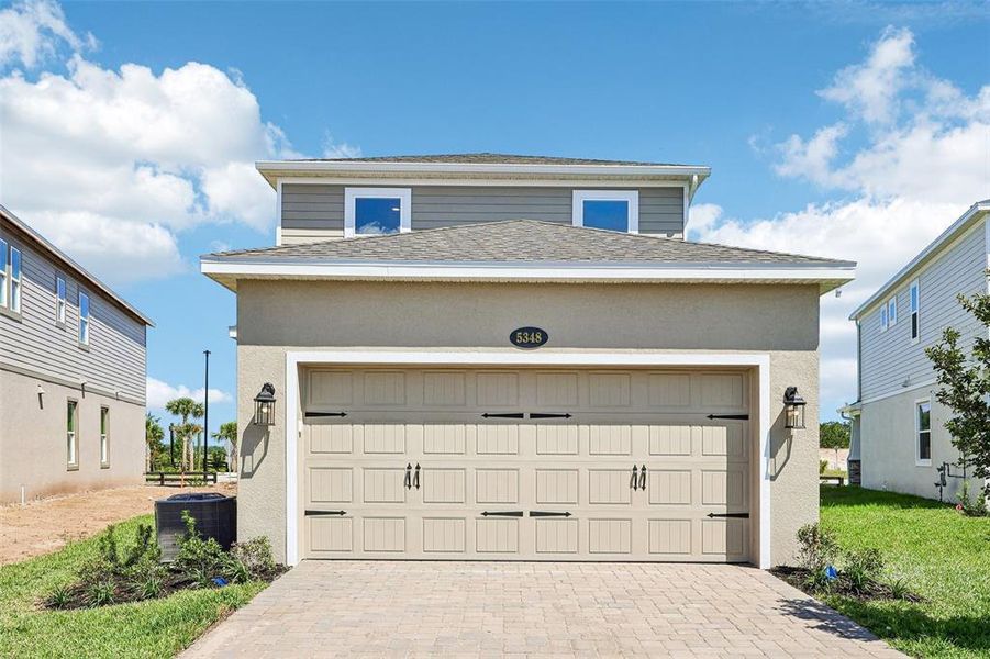 Front exterior of a new home in Center Lake on the Park, St. Cloud, FL, highlighting curb appeal (Image 2). Front exterior of a new home in Center Lake on the Park, St. Cloud, FL, highlighting curb appeal (Image 2).