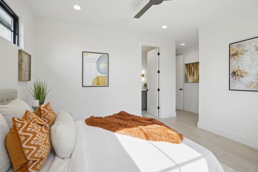 Bedroom featuring light wood-style floors, recessed lighting, a ceiling fan, and ensuite bath