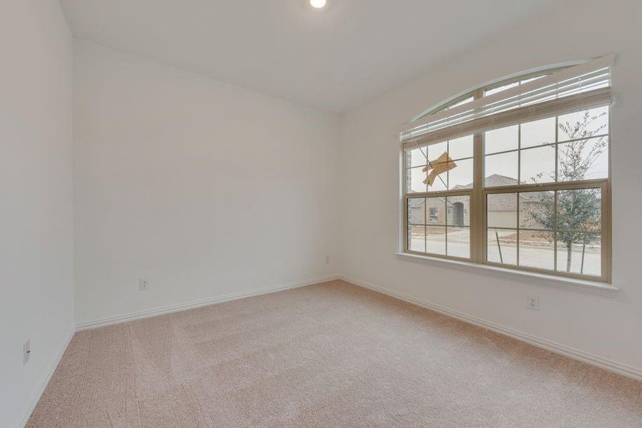 Carpeted empty room featuring a healthy amount of sunlight