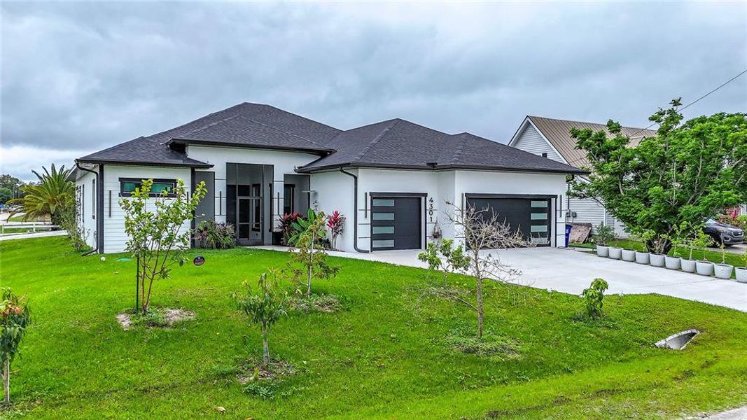 Front exterior of a new home in , Lehigh Acres, FL, highlighting curb appeal (Image 30).