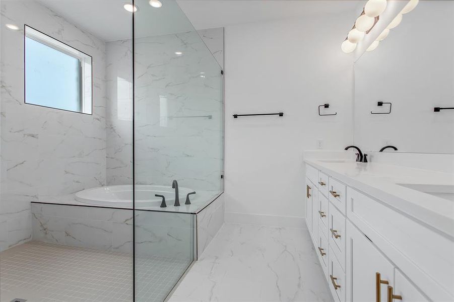 Bathroom with a relaxing tiled tub, tile patterned flooring, and dual bowl vanity