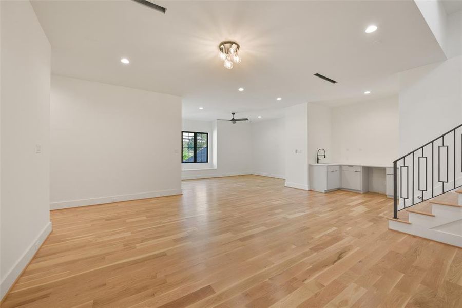 The upstairs game room flows seamlessly with the media room. Note the snack bar which has room for a refrigerator or ice maker. There is a large media closet where the wiring throughout the home is run to. It also offers walls of shelving for storage.