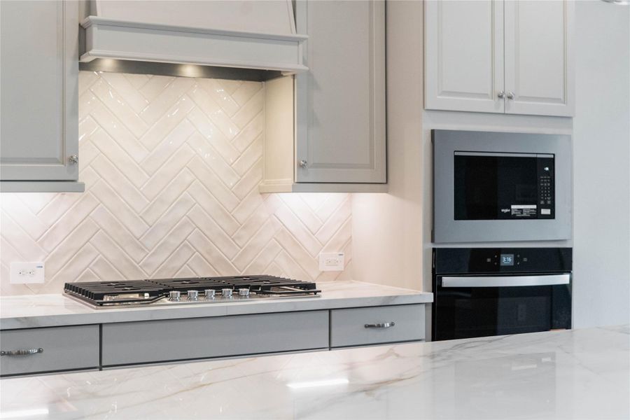 Enjoy cooking with a full suite of stainless steel appliances, including a gas cooktop with venthood, wall oven and microwave set.