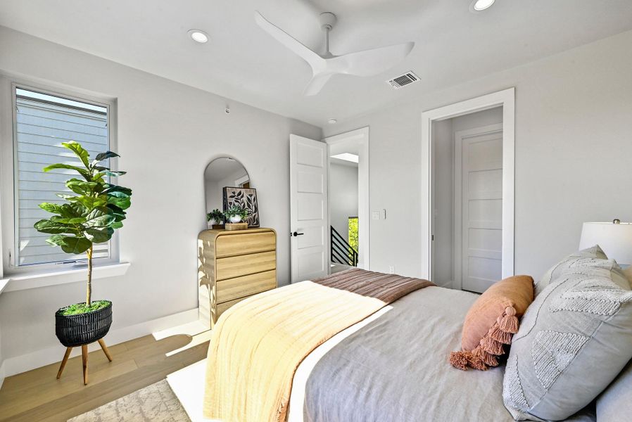 3rd Floor Primary Bedroom with a generous amount of space. (This is Unit #2 - each Unit has the same layout, however a few differing details such as light fixtures, custom cabinet/backsplash/tile colors)