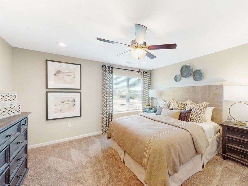 A bedroom with a bed and a fan. A bedroom with a bed and a fan.