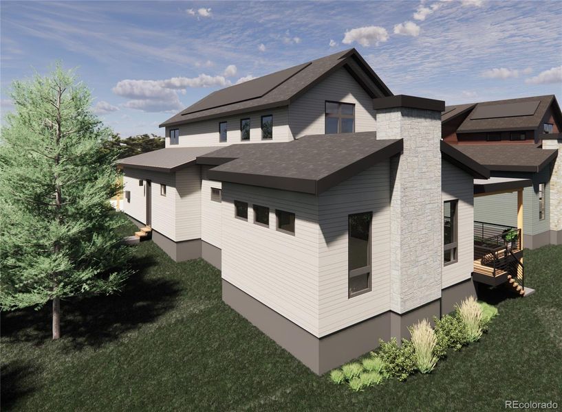 A look at the homes serene rear elevation, featuring large windows, a covered deck, and beautifully integrated outdoor living areas. Enjoy peaceful foothills surroundings, lush landscaping, and seamless indoor outdoor flow from the main living spaces.