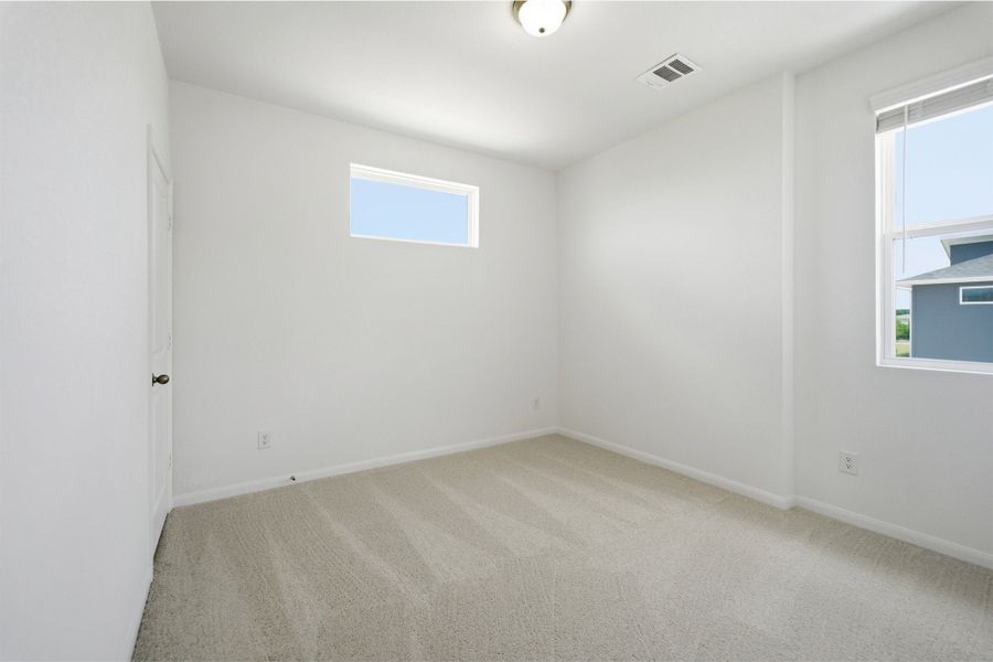 Representative unfurnished interior of a home built from the Kahn by CastleRock Communities in Municipal Drive Townhomes, Leander (Image 20).