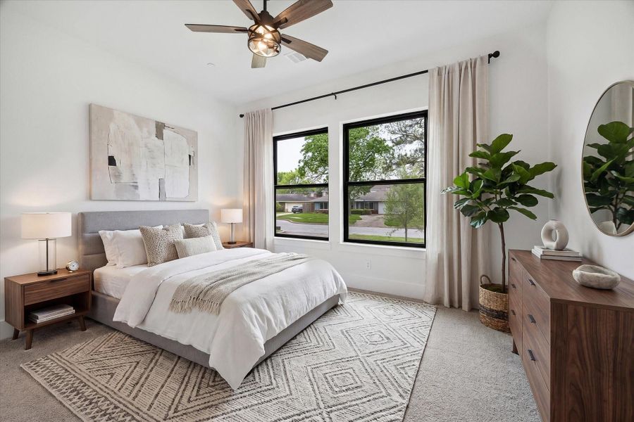 One of the secondary bedrooms is also on the first floor with an adjoining bathroom with shower. Counting the powder bath, there are 2 and a half baths downstairs. This is the only room downstairs which has carpet. (virt. staged)