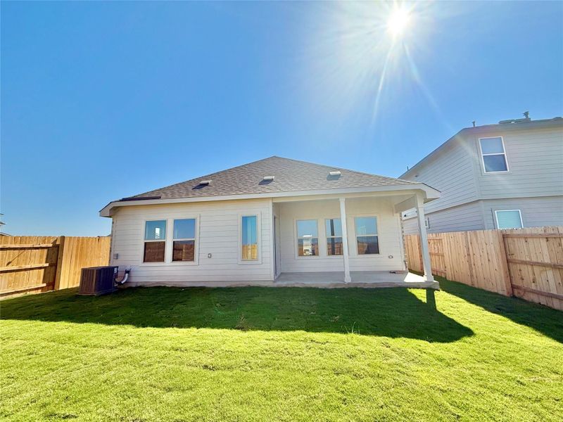 Back of property with a fenced backyard, a patio area, and roof with shingles Back of property with a fenced backyard, a patio area, and roof with shingles