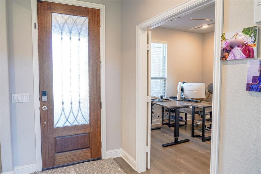 Entryway with wood finished floors and plenty of natural light