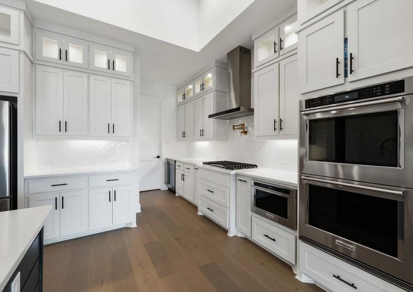 The kitchen has goregous white tile backsplash.