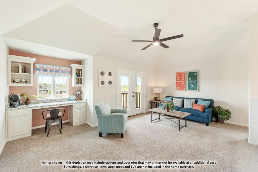 Bonus room with built-in desk, ceiling fan, carpet, and seating area with blue sofa and patio door access