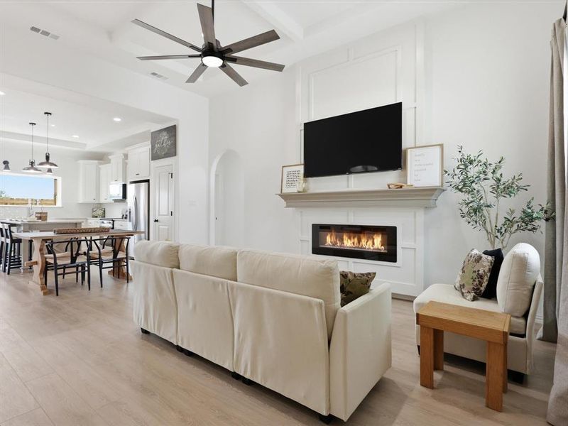 This living room with coffered ceilings and natural light is welcoming to all!