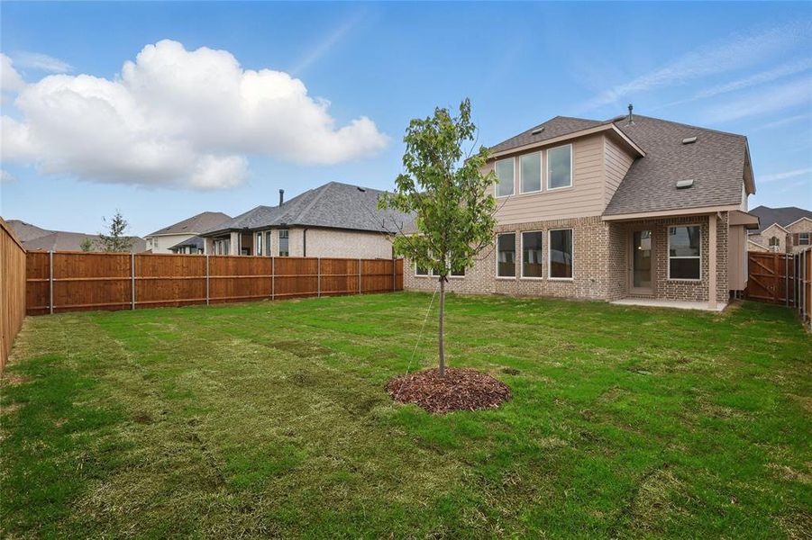 Rear view of house featuring a patio area, a shingled roof, a yard, brick siding, and a fenced backyard Rear view of house featuring a patio area, a shingled roof, a yard, brick siding, and a fenced backyard