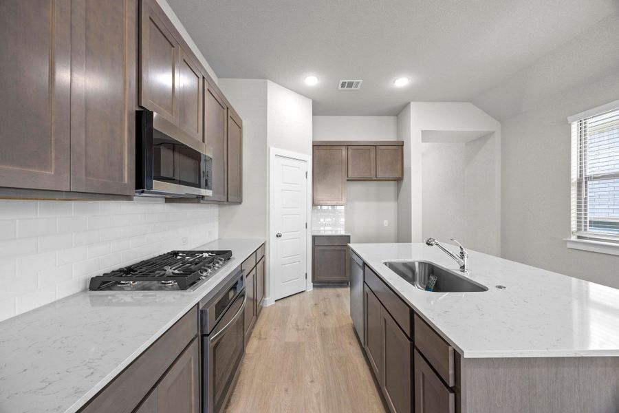 Kitchen in the Cedar home plan by Trophy Signature Homes – REPRESENTATIVE PHOTO