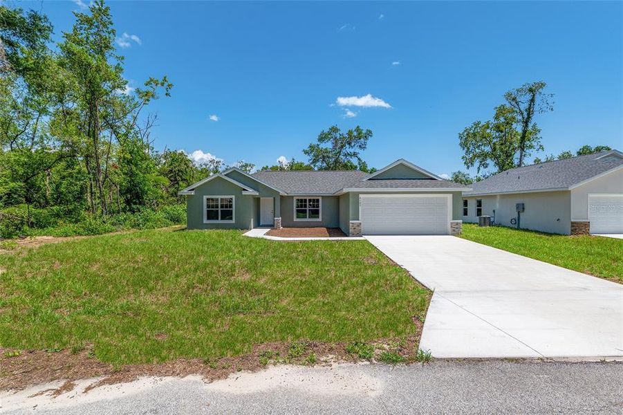 Front exterior of a new home in , Dunnellon, FL, highlighting curb appeal (Image 18).