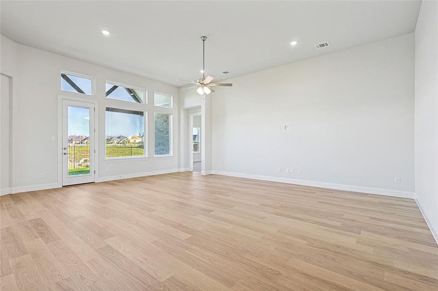 Unfurnished living room featuring light hardwood / wood-style floors and ceiling fan