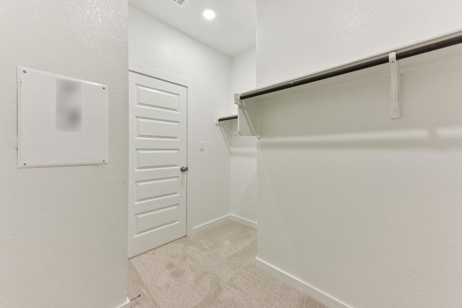A hallway with white cabinets. A hallway with white cabinets.