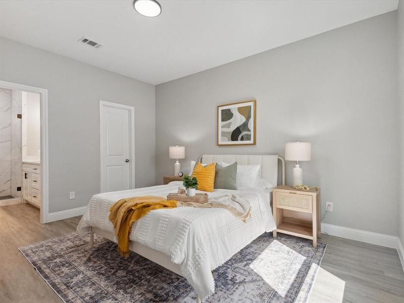 Bedroom featuring wood-type flooring and ensuite bathroom