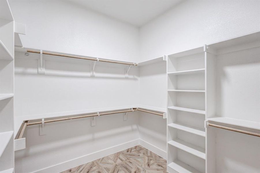 Walk in closet featuring parquet flooring