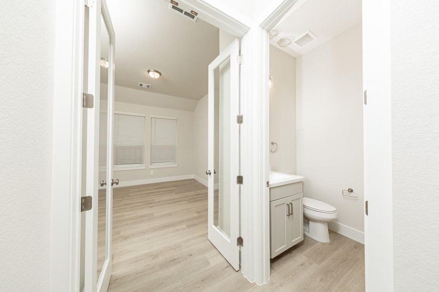 The powder bath is located conveniently near the study! The study features elegant glass French doors that allow natural light to flow seamlessly into the main living areas while maintaining quiet separation. The powder bath is located conveniently near the study! The study features elegant glass French doors that allow natural light to flow seamlessly into the main living areas while maintaining quiet separation.