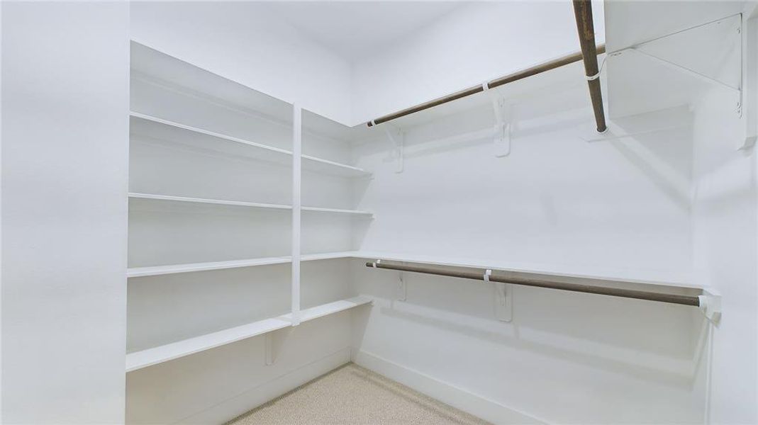 The primary closet is impressively large, providing ample storage and organization for all your wardrobe needs