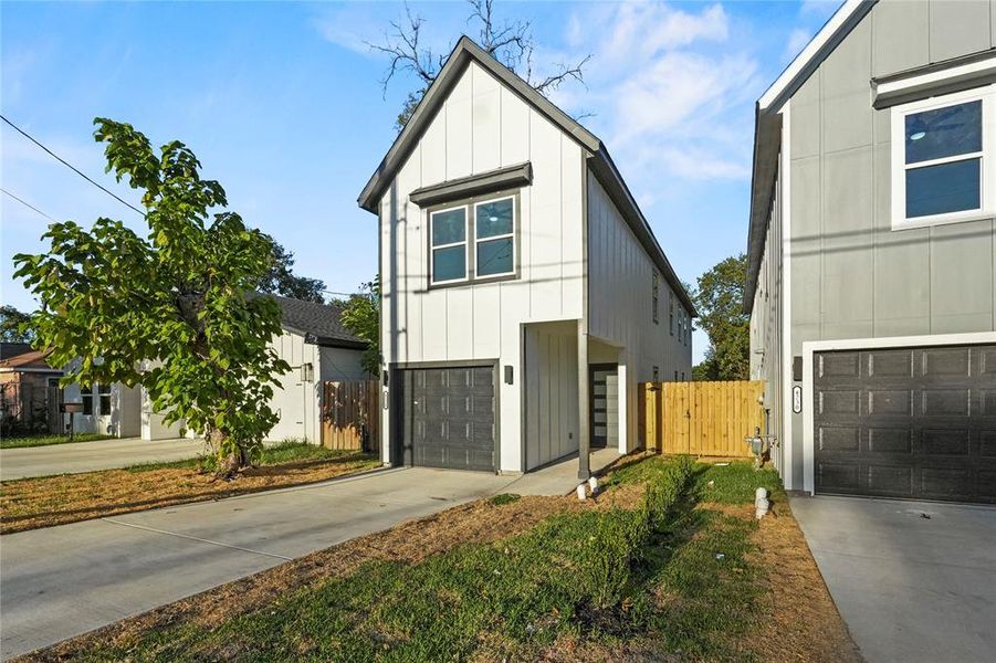 Modern farmhouse style home featuring board and batten siding, concrete driveway, and a garage Modern farmhouse style home featuring board and batten siding, concrete driveway, and a garage