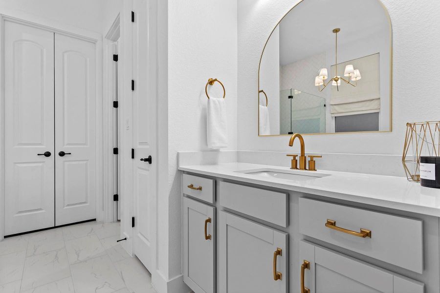 Bathroom featuring vanity, an enclosed shower, and a chandelier