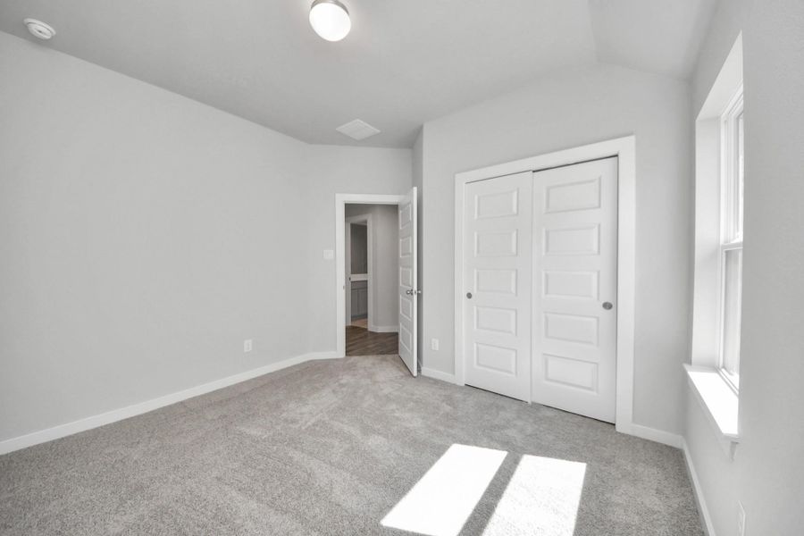 Generously sized secondary bedrooms featuring spacious closets, soft and inviting carpeting underfoot, large windows allowing plenty of natural light, and the added touch of privacy blinds for your personal retreat. Sample photo of completed home with similar floor plan. Actual colors and selections may vary. Generously sized secondary bedrooms featuring spacious closets, soft and inviting carpeting underfoot, large windows allowing plenty of natural light, and the added touch of privacy blinds for your personal retreat. Sample photo of completed home with similar floor plan. Actual colors and selections may vary.