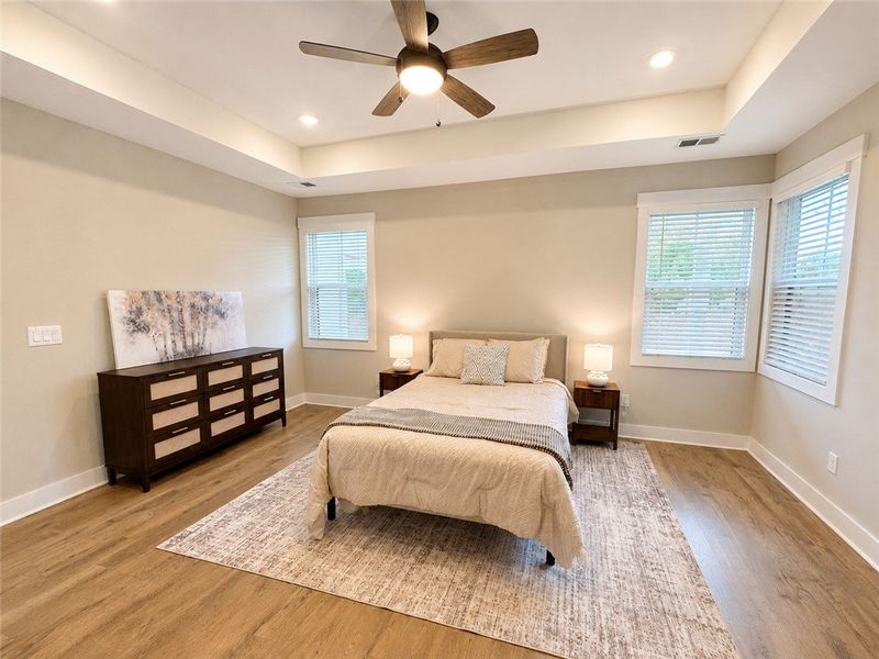 A tranquil bedroom features a tray ceiling with re A tranquil bedroom features a tray ceiling with re