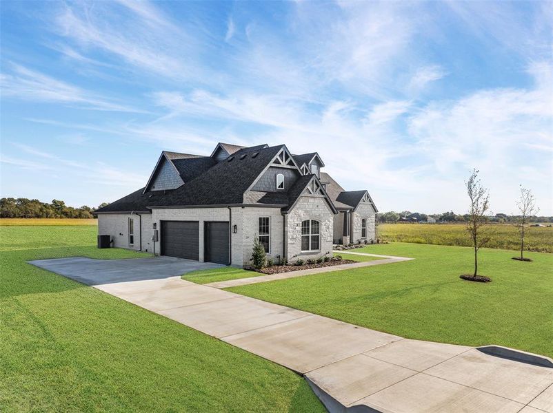 Front exterior of a new home in Waterfall Ranch - 1 Acre Lots, Waxahachie, TX, highlighting curb appeal (Image 17). Front exterior of a new home in Waterfall Ranch - 1 Acre Lots, Waxahachie, TX, highlighting curb appeal (Image 17).