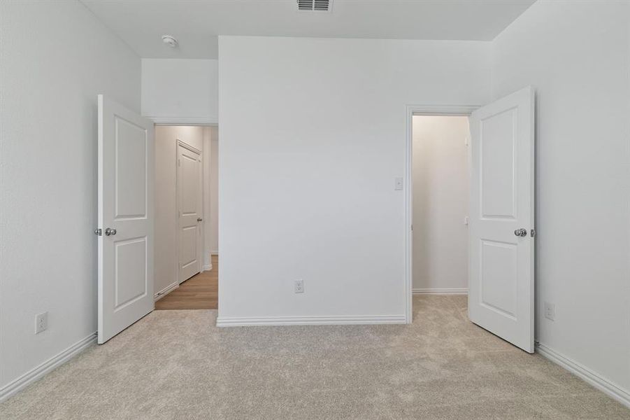 Unfurnished bedroom featuring light carpet
