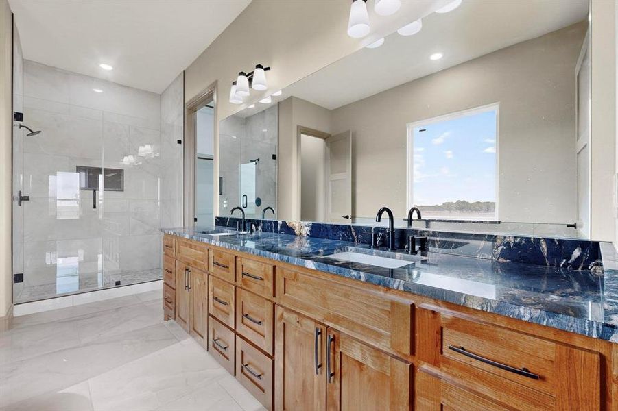 Bathroom featuring light marble finish flooring, double vanity, a stall shower, and recessed lighting Bathroom featuring light marble finish flooring, double vanity, a stall shower, and recessed lighting