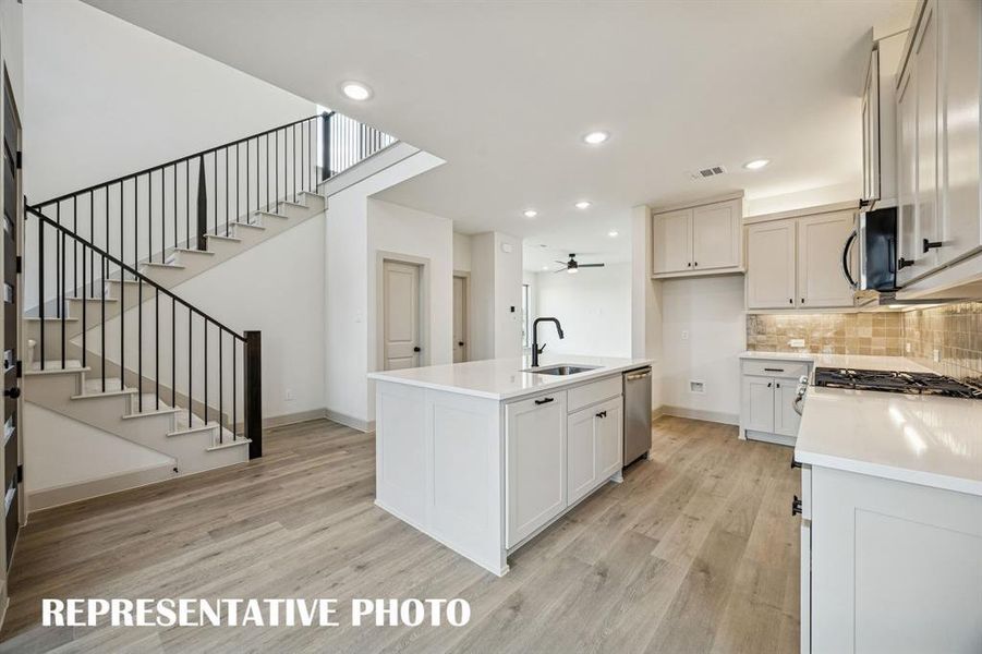 Beautiful cabinetry, gorgeous counter tops and contemporary railings create a contemporary dream kitchen!  REPRESENTATIVE PHOTO
