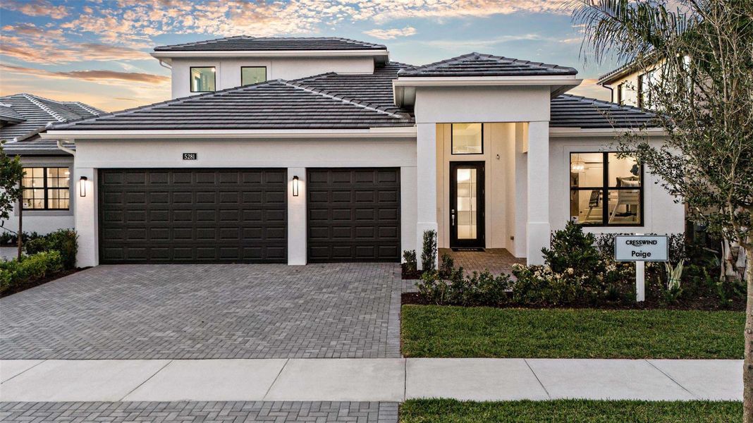 Front exterior of a new home in Cresswind Palm Beach at Westlake, Westlake, FL, highlighting curb appeal (Image 1).