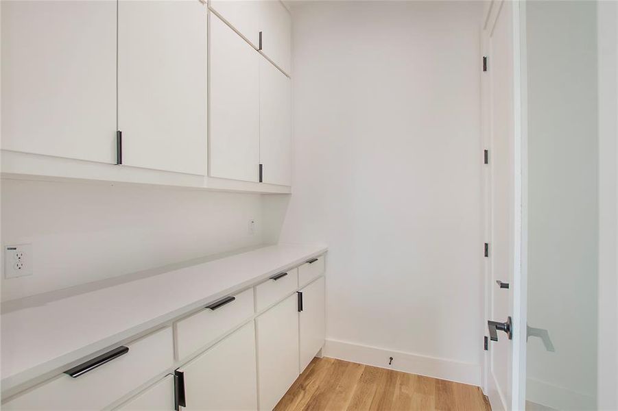 Hallway with light hardwood / wood-style flooring