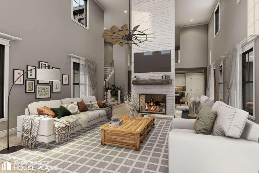 Living room with a high ceiling, wood finished floors, a stone fireplace, and ceiling fan