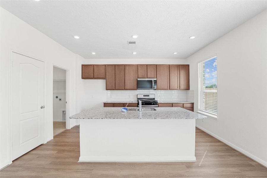 This spacious kitchen has it all—ample storage, generous counter space, and a layout that truly makes it the heart of the home. This spacious kitchen has it all—ample storage, generous counter space, and a layout that truly makes it the heart of the home.