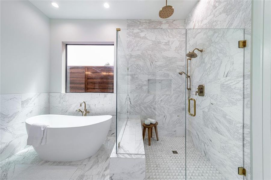 Full bath with a freestanding tub, a marble finish shower, tile walls, recessed lighting, and marble finish floors