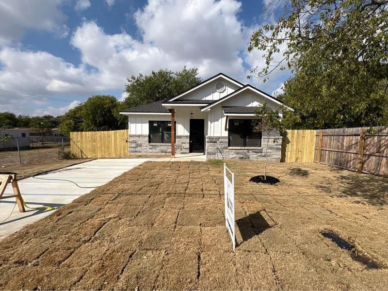 View of front of house featuring stone siding and board and batten siding View of front of house featuring stone siding and board and batten siding