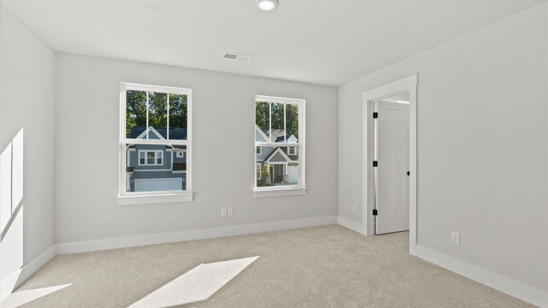 Vibrant and restful bedroom with oversized windows, refined detail, and a warm, welcoming atmosphere