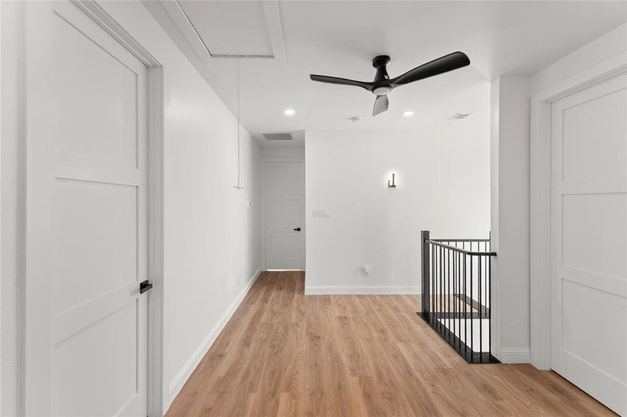 Empty room with ceiling fan, light wood-style flooring, and recessed lighting